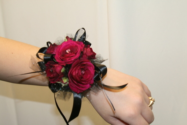 Wine and black spray rose wrist corsage from The Posie Shoppe in Prineville, OR